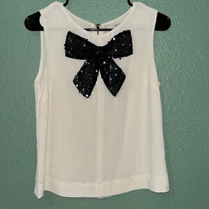 Dressy sleeveless blouse with sequinced bow